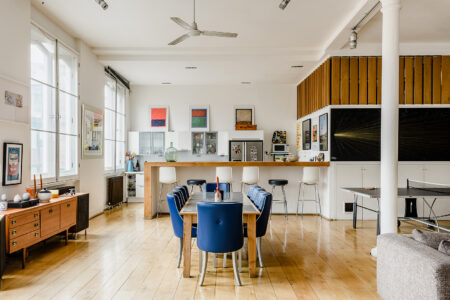 A dramatic open-plan reception with double-height ceilings and a kitchen in the south-westerly corner